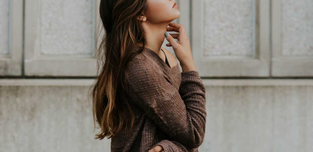 Young woman pondering looking up.