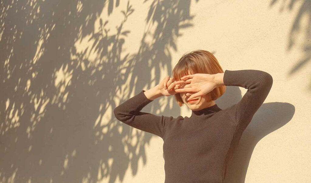 Woman shielding her eyes from the sun.