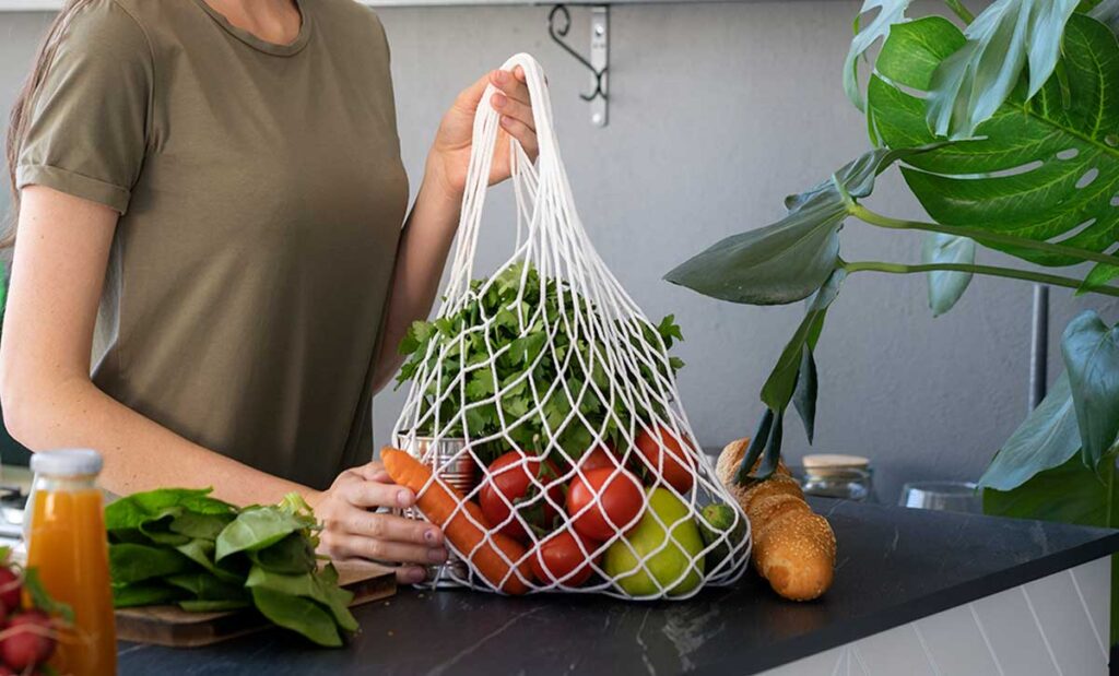 Woman shopping with fabric tote bag.